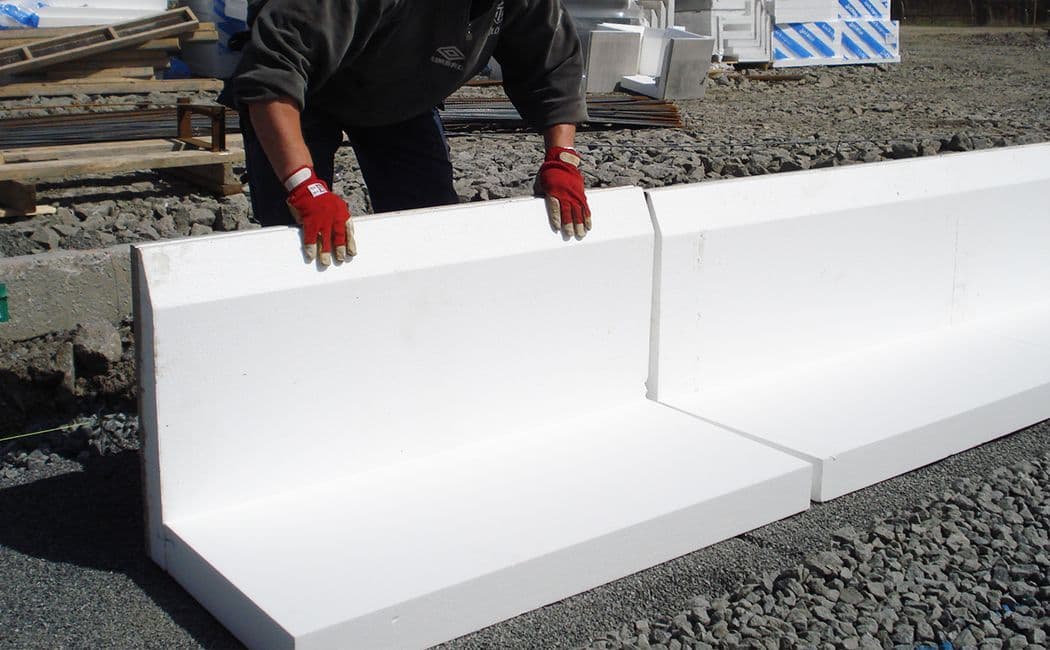 Person som holder på med isolasjon av grunnen.