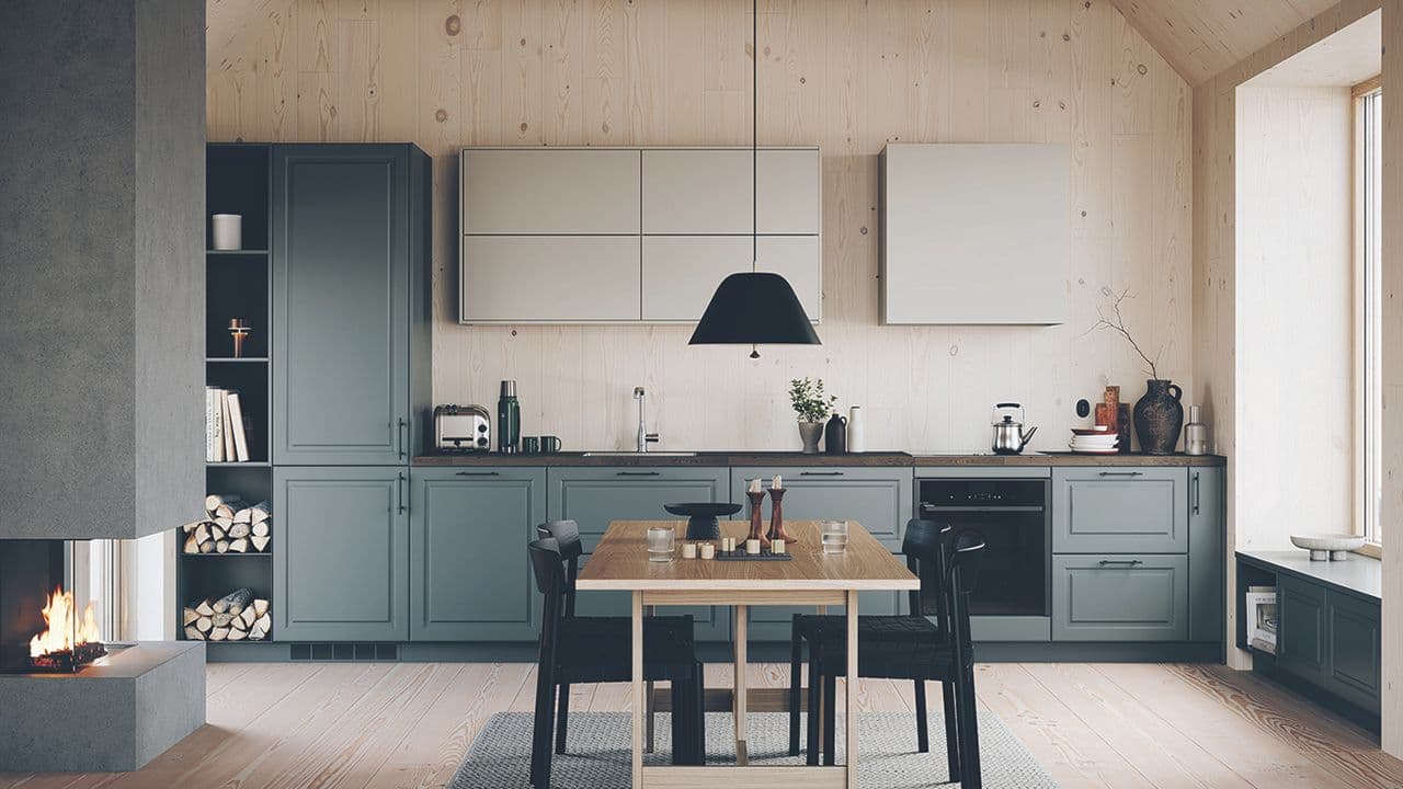 Hyttekjøkken med furuvegger og grønngrå og beige kjøkkeninnredning.