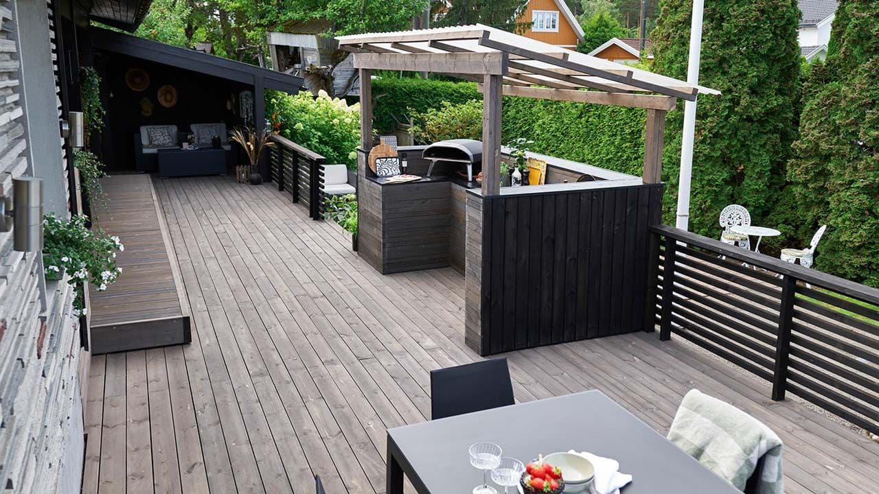 Utekjøkken med tak og halvvegger rundt.